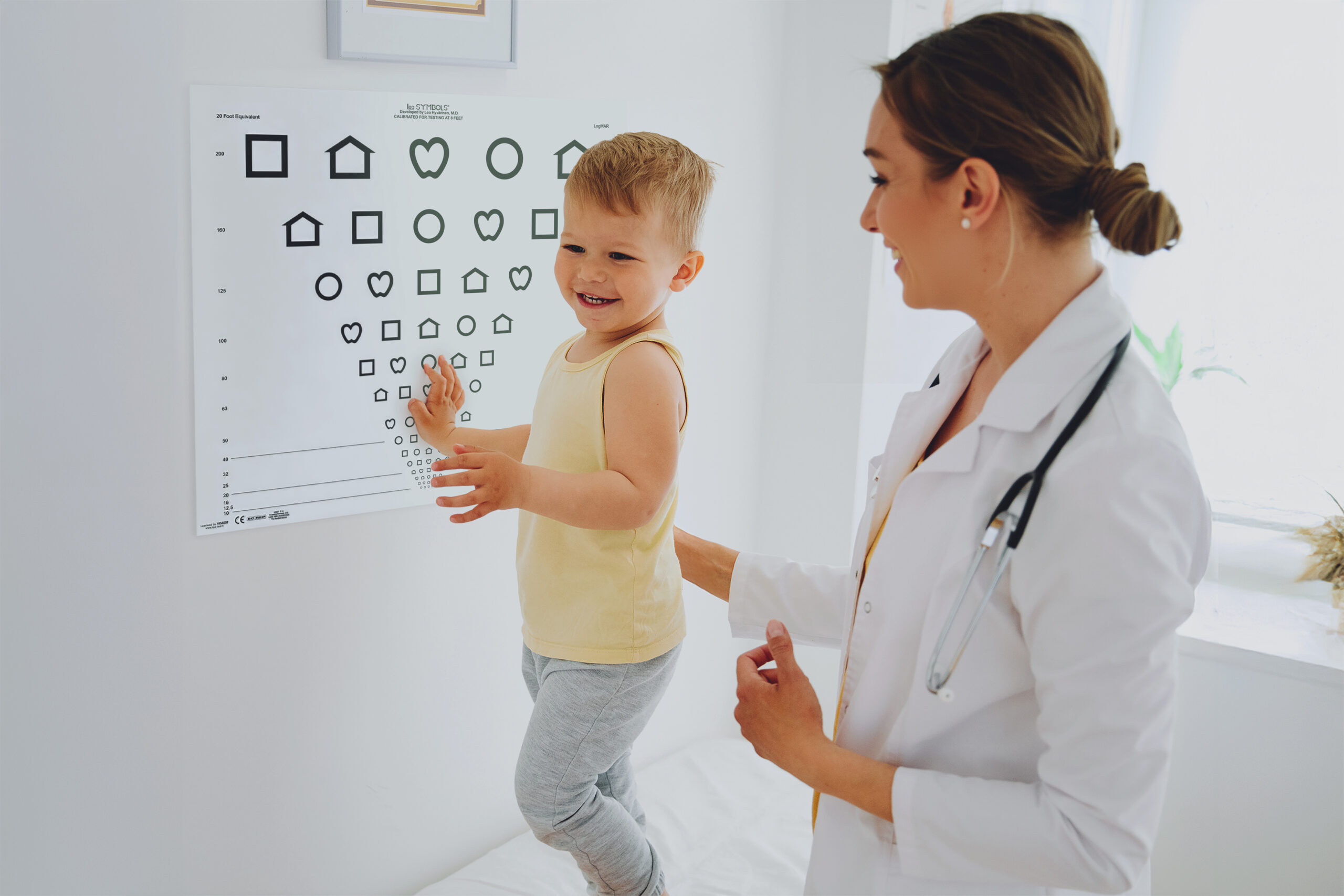 Female doctor or nurse with a little boy in doctor's office in clinic