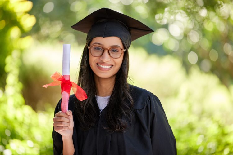 Cropped portrait of an attractive young female graduate posing outside with her degree.